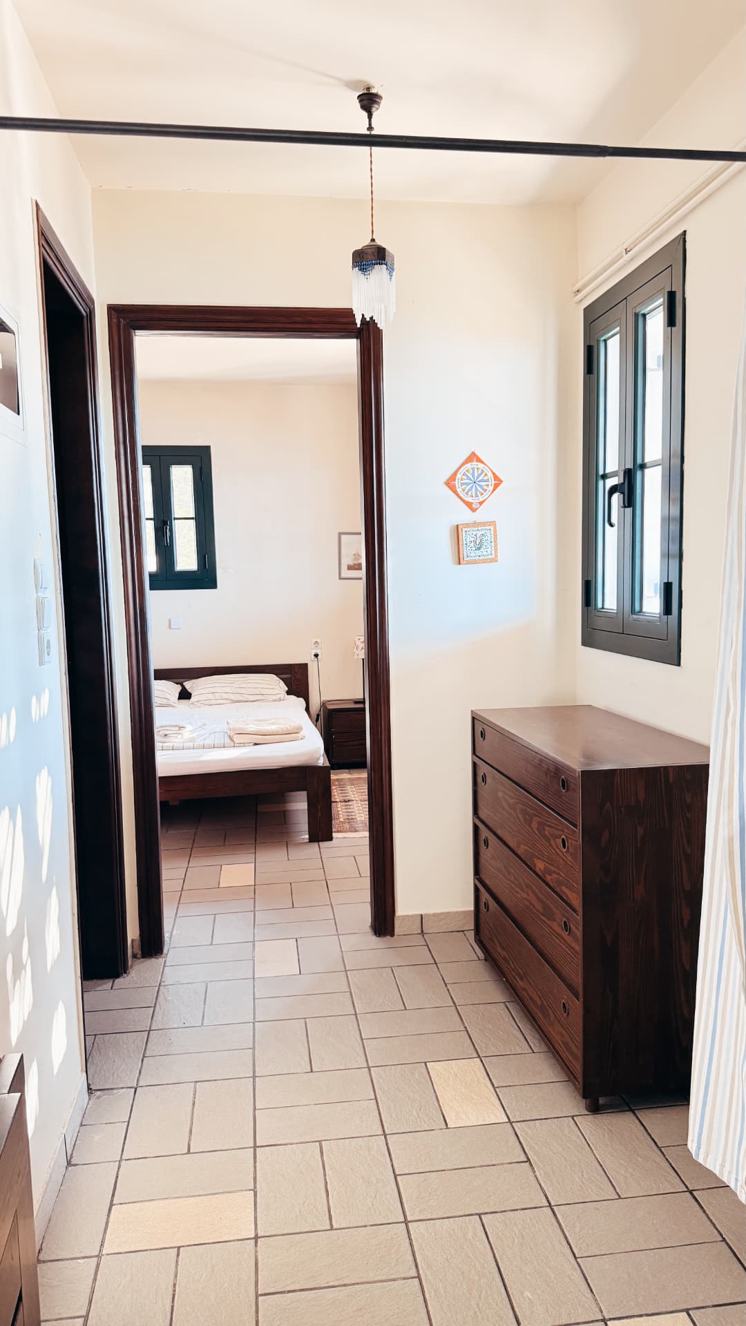Ground-floor hall with chest of drawers and a view into the bedroom