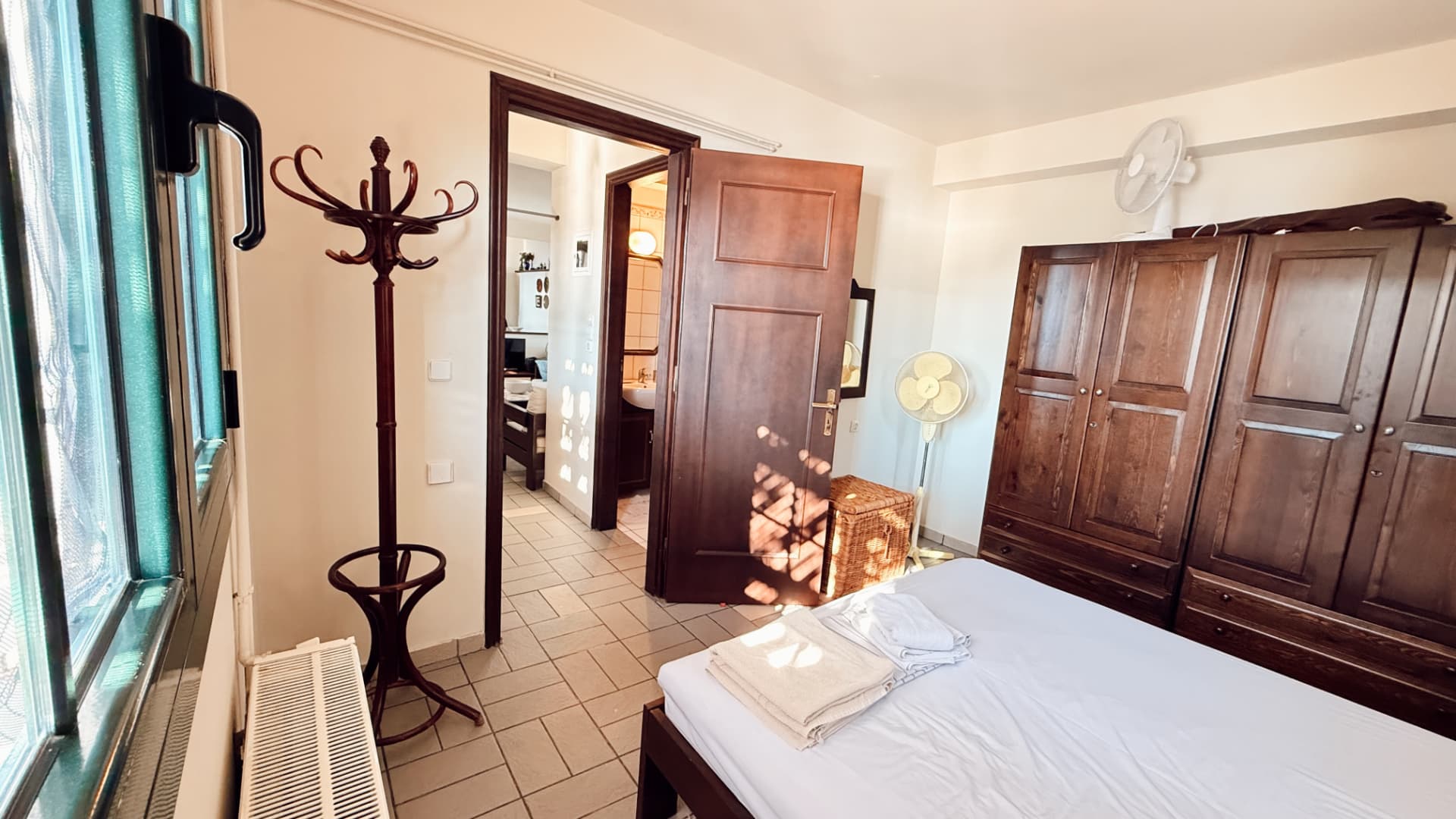 Ground-floor master bedroom with wardrobes and an open door to the hall